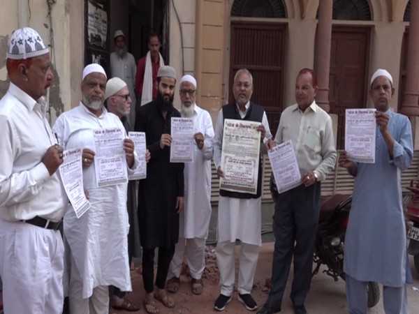People of the community member display pamphlets in Agra. (Photo/ANI) 
