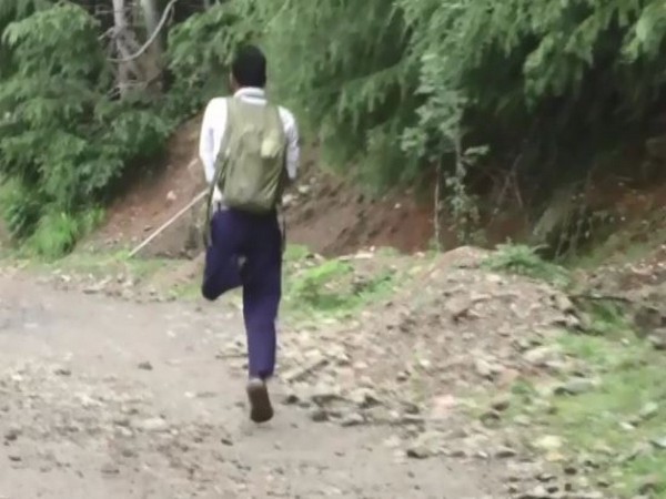 A specially-abled boy named Parvaiz walks to school on one leg to pursue his dreams in Handwara (Photo/ANI)