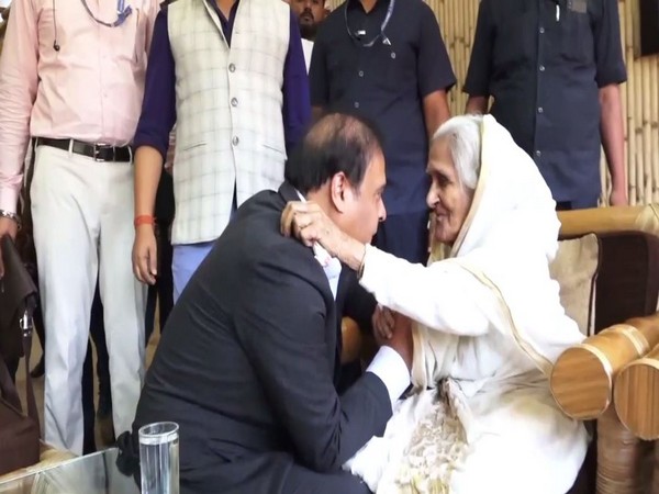 Assam Chief Minister Himanta Biswa Sarma meets an elderly woman in Kaziranga today. (Photo/ANI)